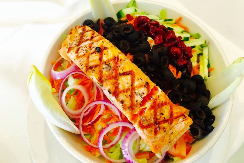 Grilled salmon over a garden salad