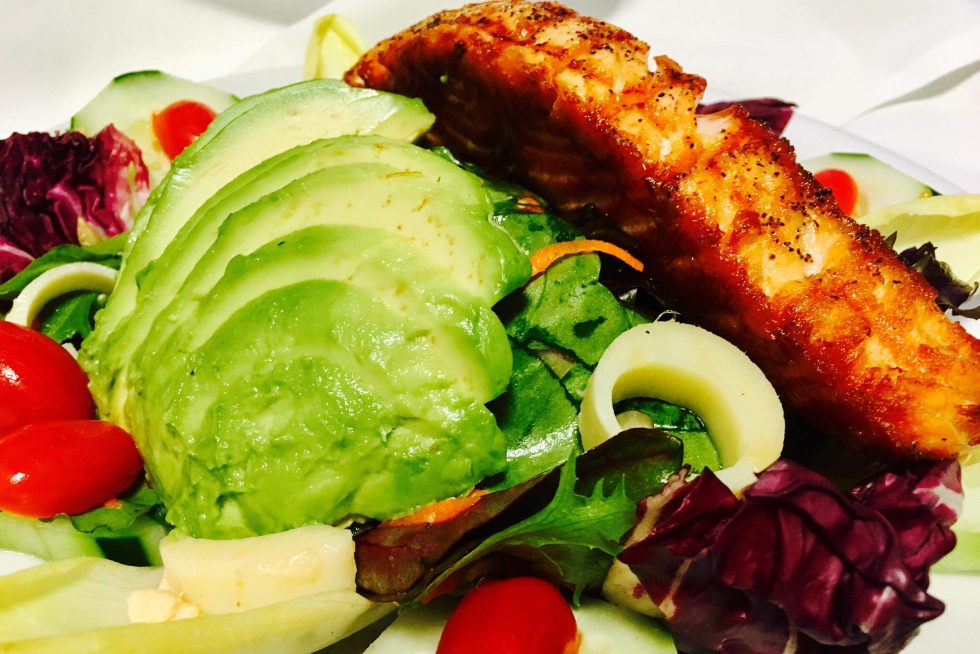 Grilled salmon over a fresh salad
